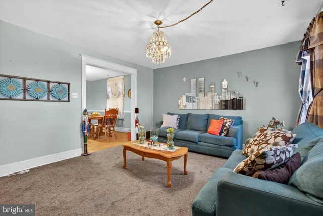 a living room with furniture and a chandelier