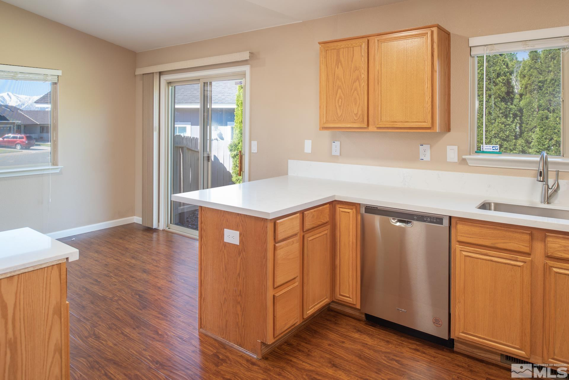 923 Ranchview Circle Carson City, NV 89705 - Photo 13 of 27 a kitchen with stainless steel appliances granite countertop a sink a microwave cabinets and wooden floor