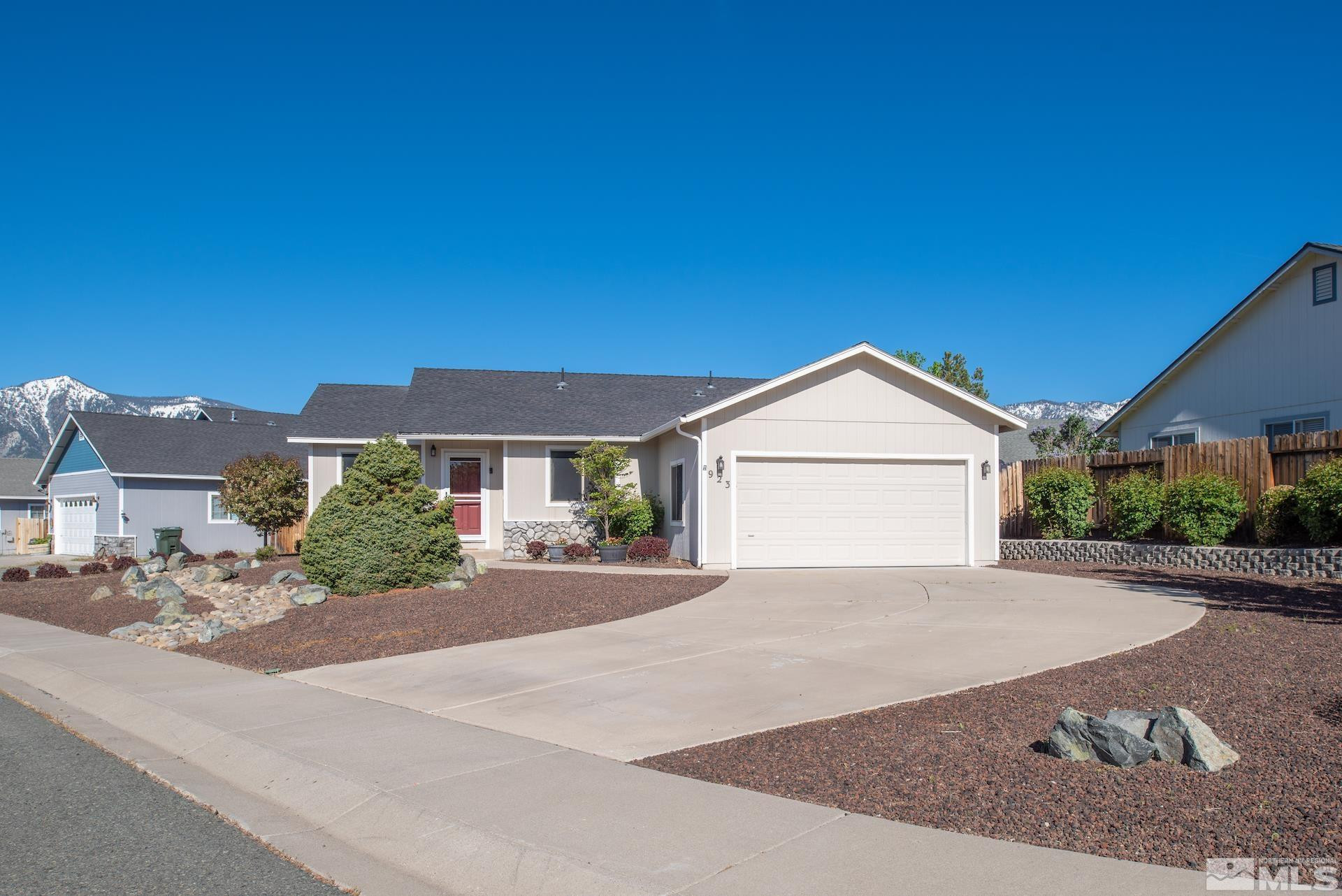 923 Ranchview Circle Carson City, NV 89705 - Photo 2 of 27 a front view of a house with a yard and garage