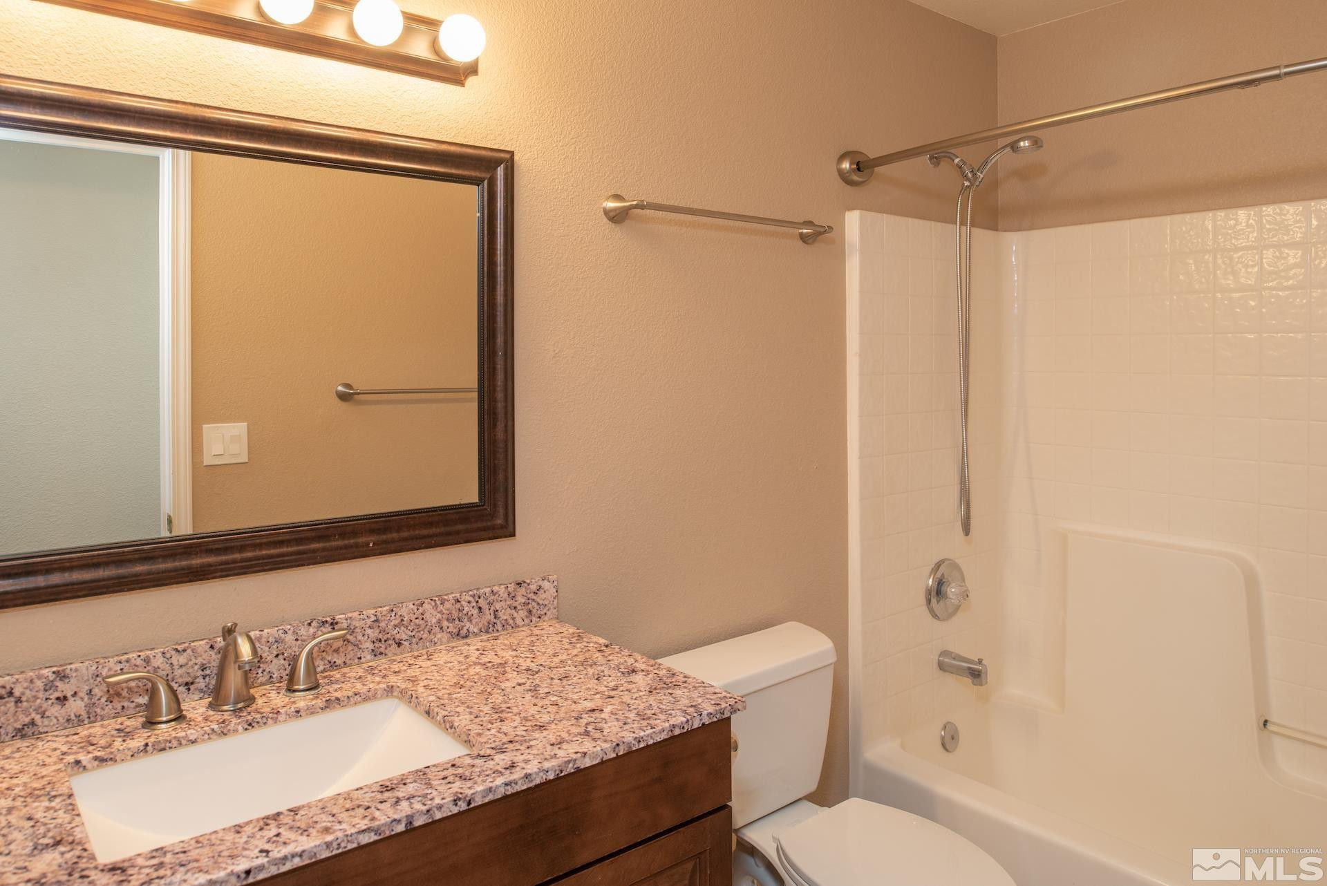 923 Ranchview Circle Carson City, NV 89705 - Photo 22 of 27 a bathroom with a granite countertop sink toilet and shower