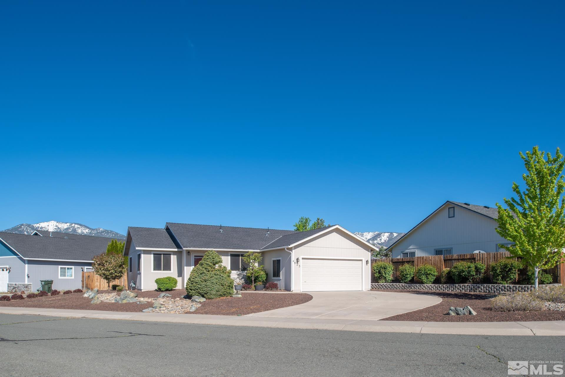 923 Ranchview Circle Carson City, NV 89705 - Photo 3 of 27 a front view of a house with a garden