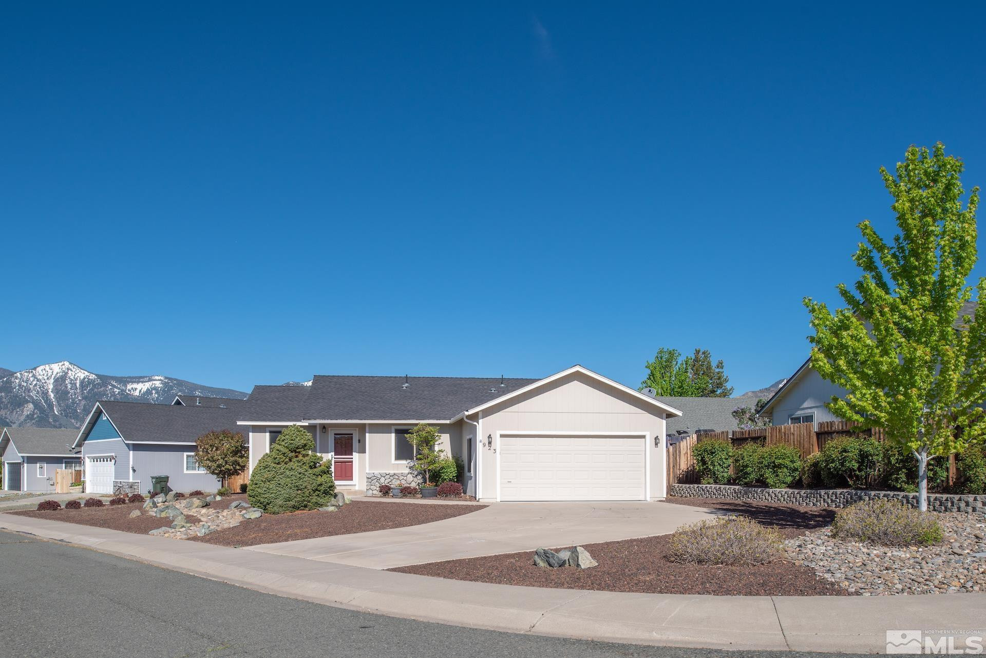 923 Ranchview Circle Carson City, NV 89705 - Photo 4 of 27 a front view of a house with a garden and yard
