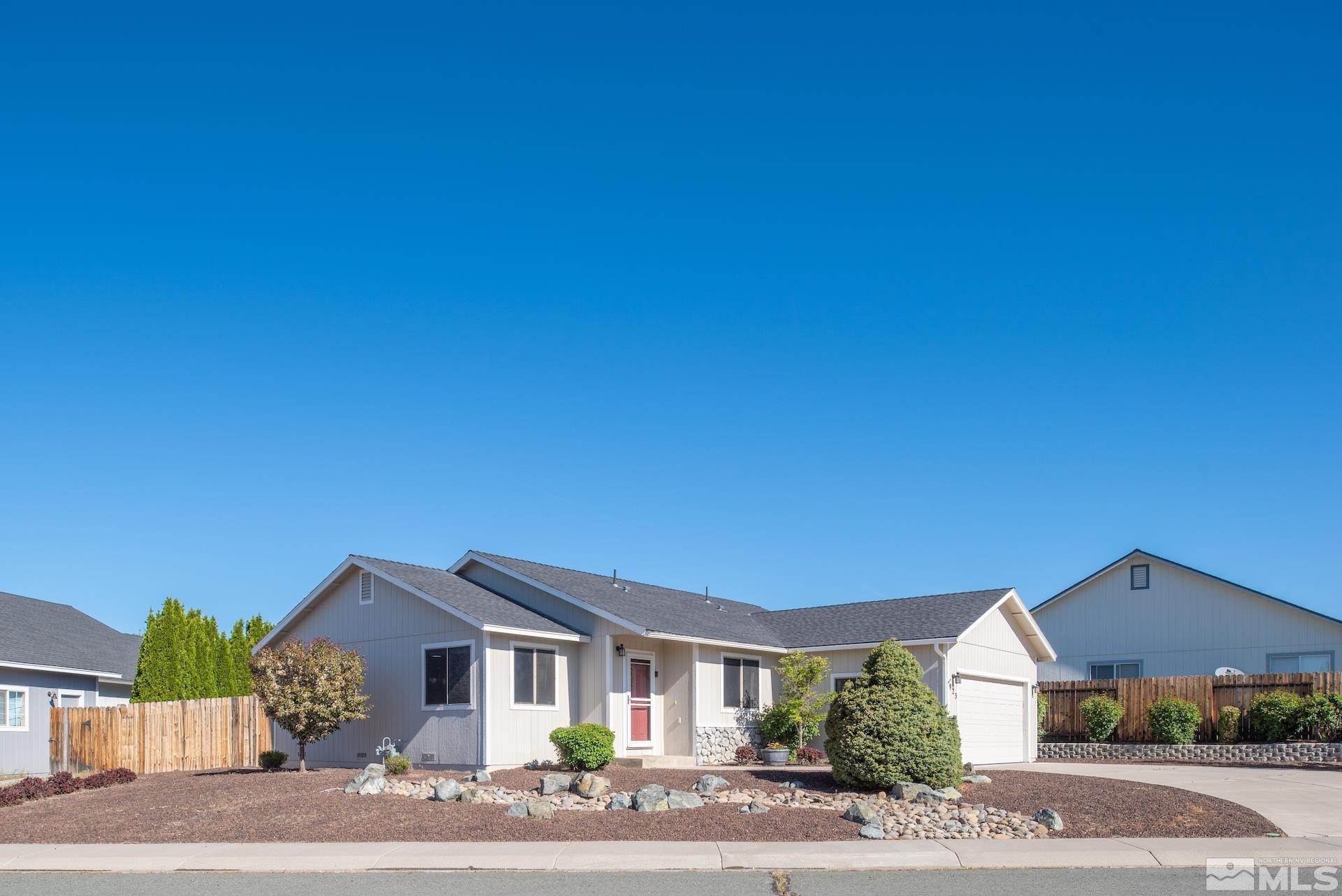 923 Ranchview Circle Carson City, NV 89705 - Photo 5 of 27 a front view of a house with a yard and garage