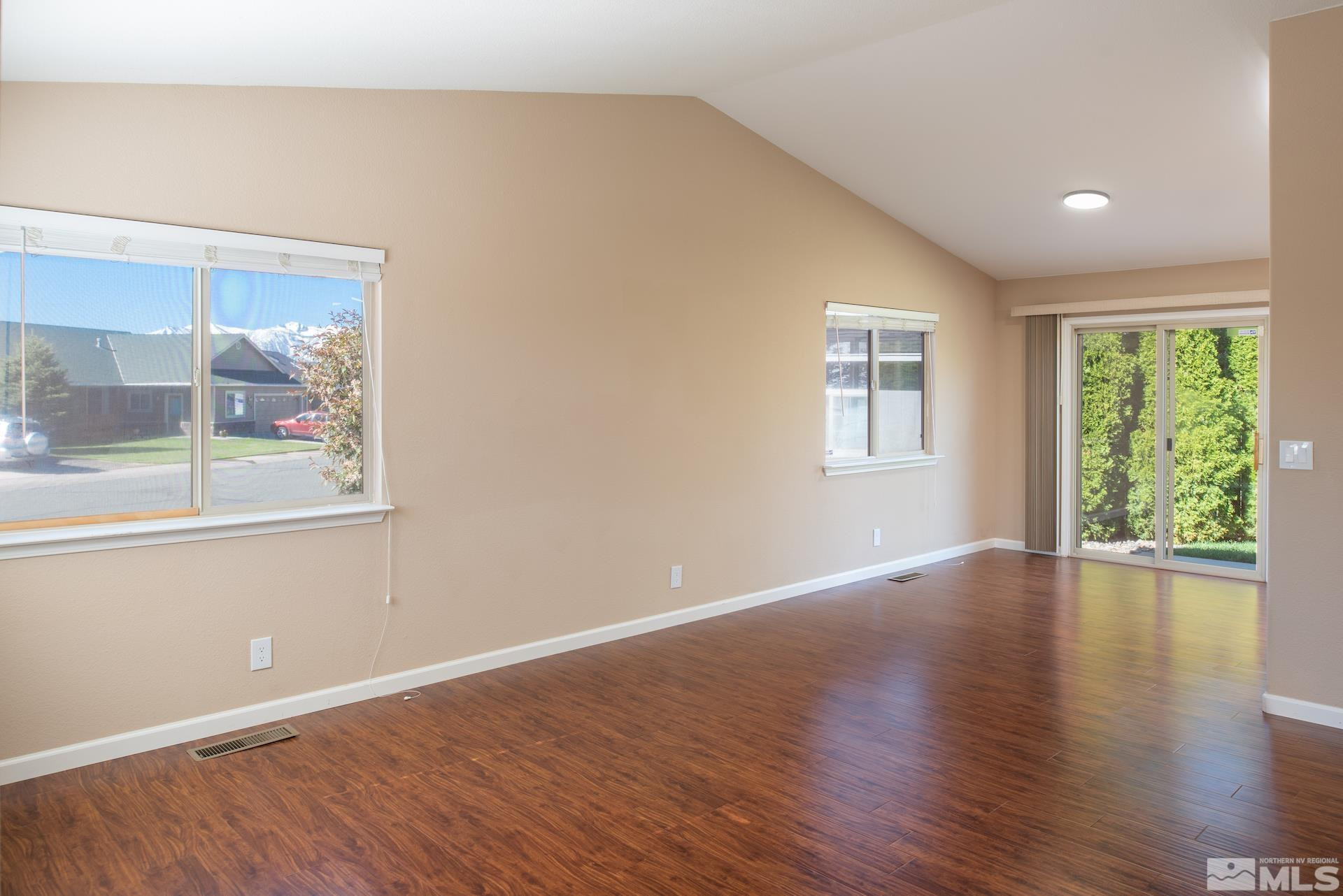923 Ranchview Circle Carson City, NV 89705 - Photo 6 of 27 an empty room with wooden floor and windows