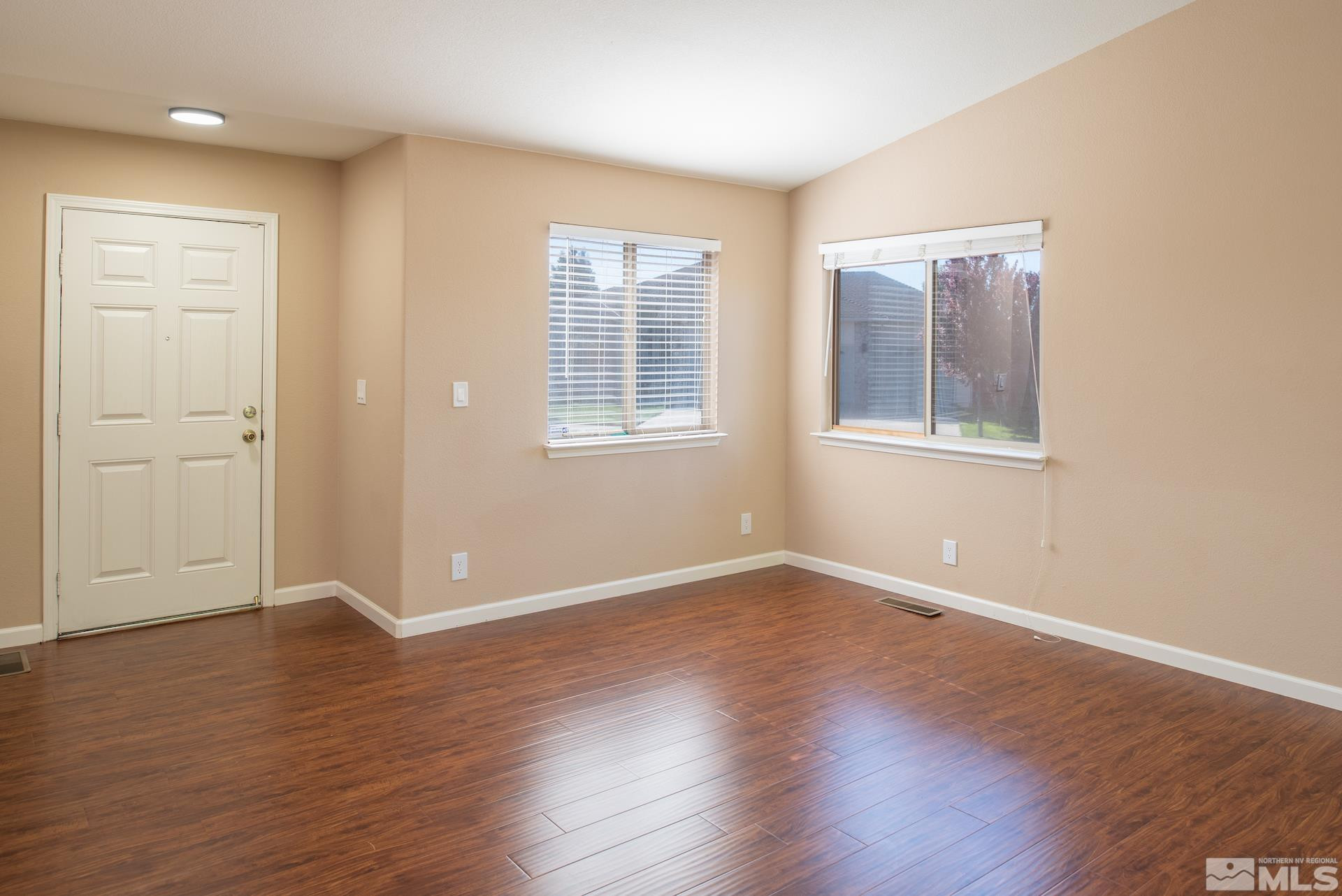 923 Ranchview Circle Carson City, NV 89705 - Photo 7 of 27 an empty room with wooden floor and windows