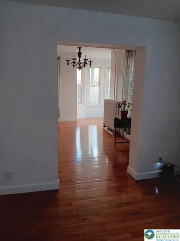 a front view of a house with hardwood floor and chandelier