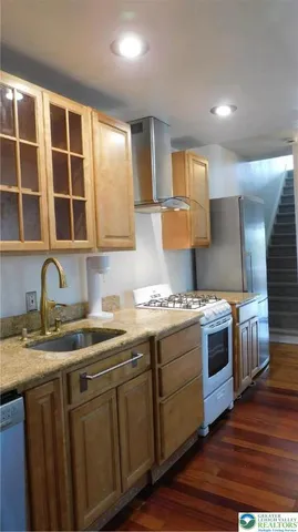 a view of a livingroom with wooden floor and a chandelier