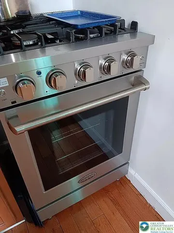 a view of a porch with a potted plant and a floor to ceiling window