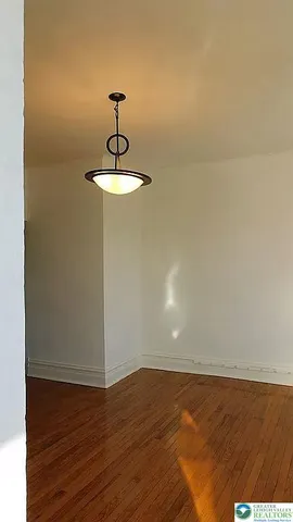 a view of a livingroom with furniture window and wooden floor