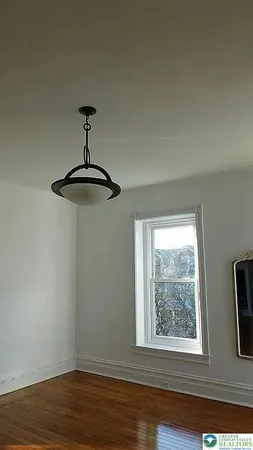 a bathroom with a sink a toilet a window and shower