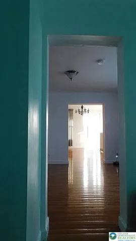 a bathroom with a sink a toilet a window and shower