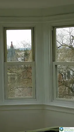 a view of a room with a window and dining area
