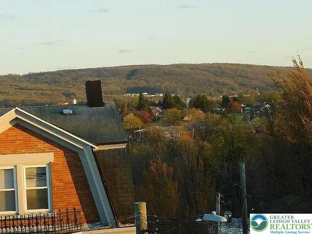 a view of a street with houses on both side