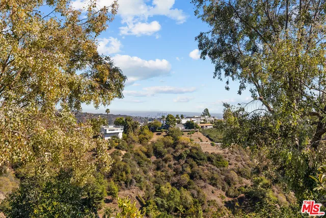 an aerial view of residential houses with outdoor space and swimming pool