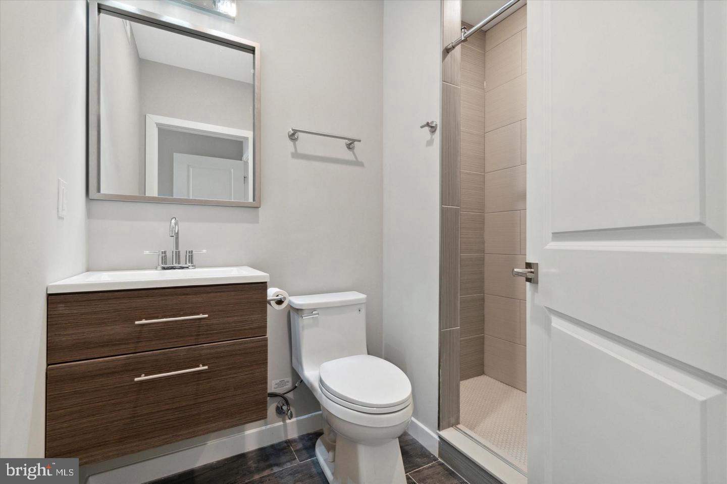 2424 Nicholas Street Philadelphia, PA 19121 - Photo 3 of 18 a bathroom with a toilet sink vanity and mirror