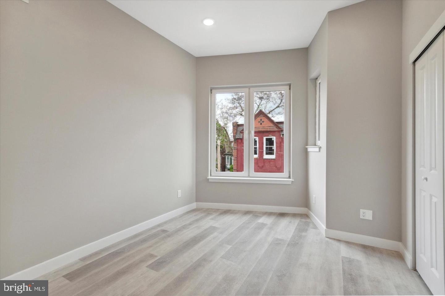 2424 Nicholas Street Philadelphia, PA 19121 - Photo 6 of 18 an empty room with windows view and wooden floor