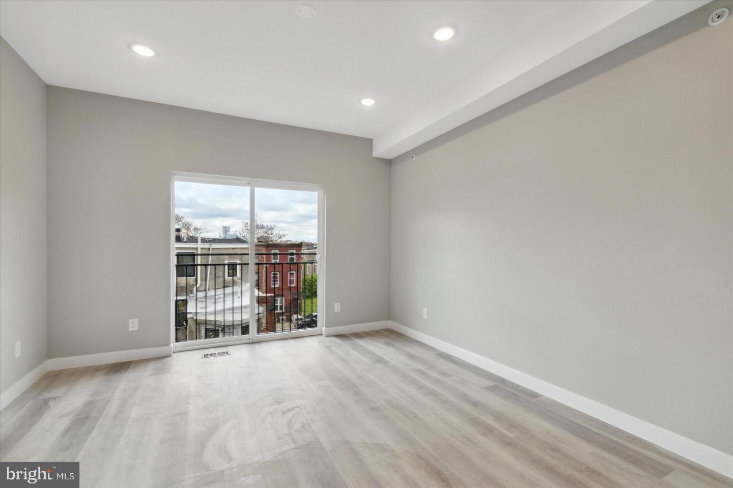 2424 Nicholas Street Philadelphia, PA 19121 - Photo 8 of 18 an empty room with wooden floor and windows