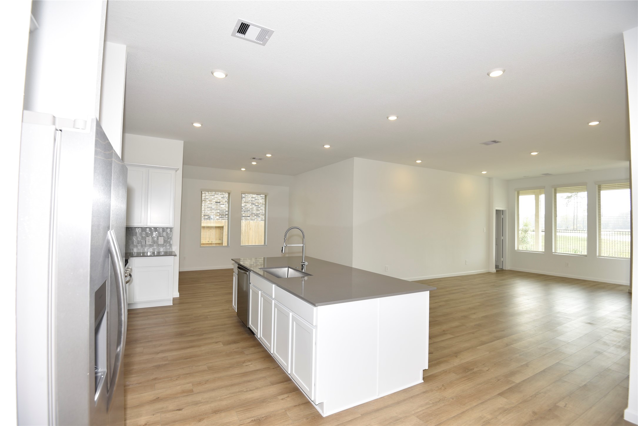 15524 Leopard Lily Lane Conroe, TX 77302 - Photo 12 of 47 a open kitchen with stainless steel appliances granite countertop a refrigerator and a sink