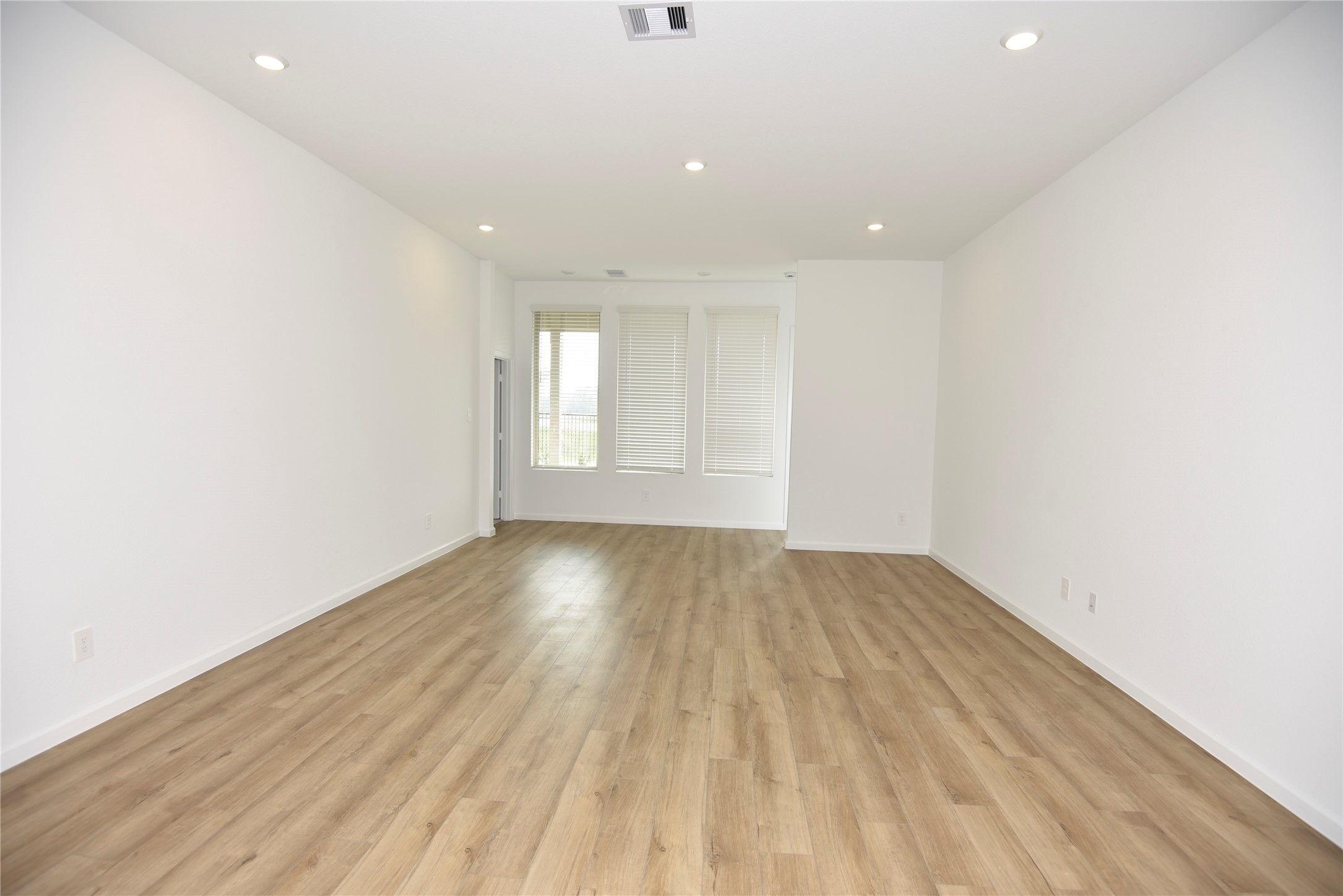 15524 Leopard Lily Lane Conroe, TX 77302 - Photo 28 of 47 a view of empty room with wooden floor