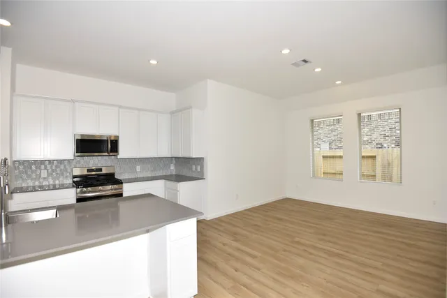 a kitchen with a appliances and a counter top space