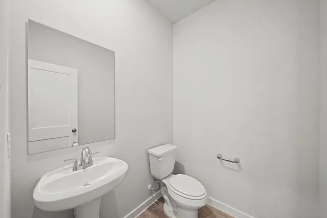 a bathroom with a toilet a sink and a mirror