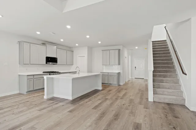 a kitchen with white cabinets and white appliances