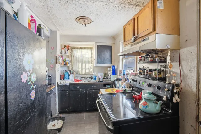 a kitchen filled with stainless steel appliances granite countertop a sink dishwasher and cabinets with wooden floor