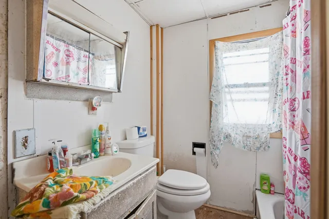 a bath room with a toilet and a bath tub