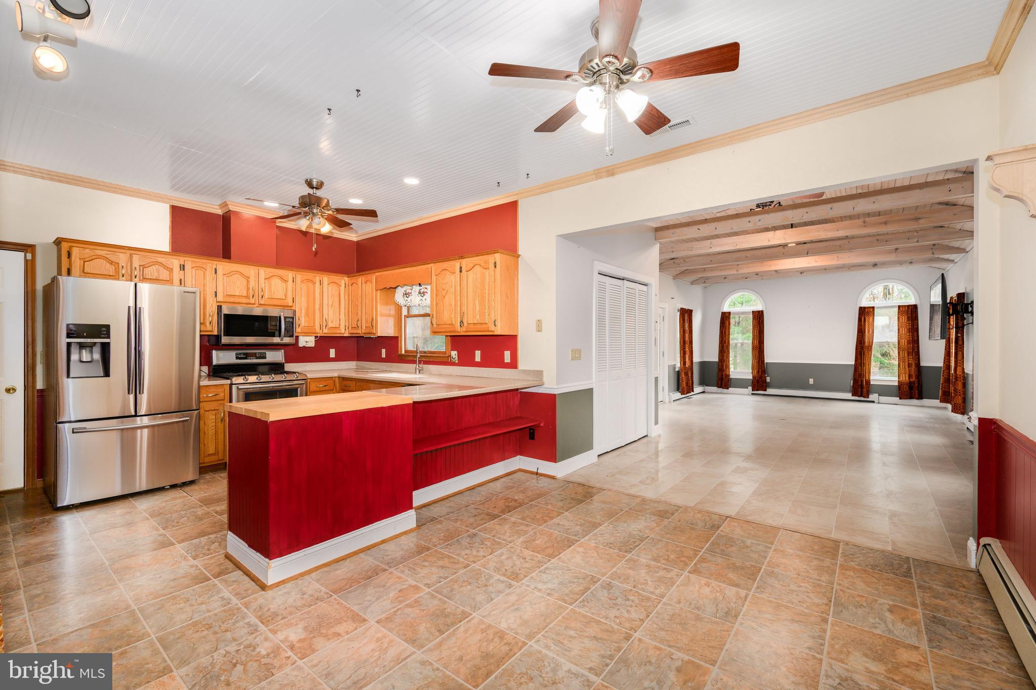 24029 Meadows Drive Ridgely, MD 21660 - Photo 11 of 39 a kitchen with stainless steel appliances granite countertop a refrigerator and a stove