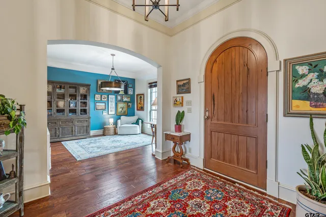 a view of an entryway with wooden floor and a rug