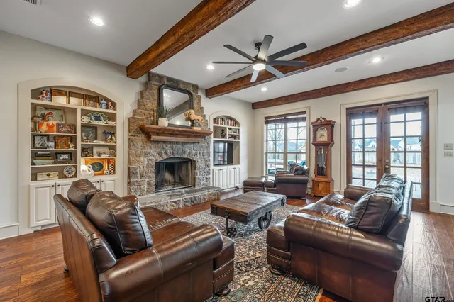 a living room with furniture ceiling fan and a fireplace