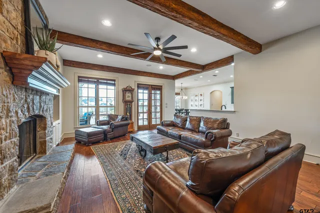 a living room with furniture a fireplace and a chandelier