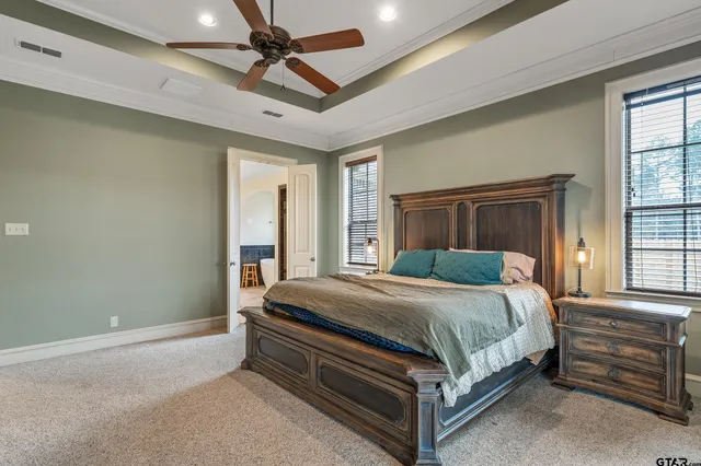 a bed sitting in a room next to a window