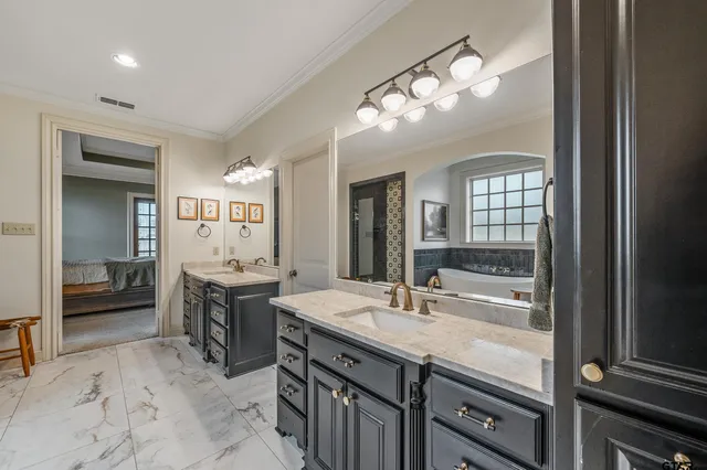 a bathroom with a granite countertop sink a large mirror and a shower