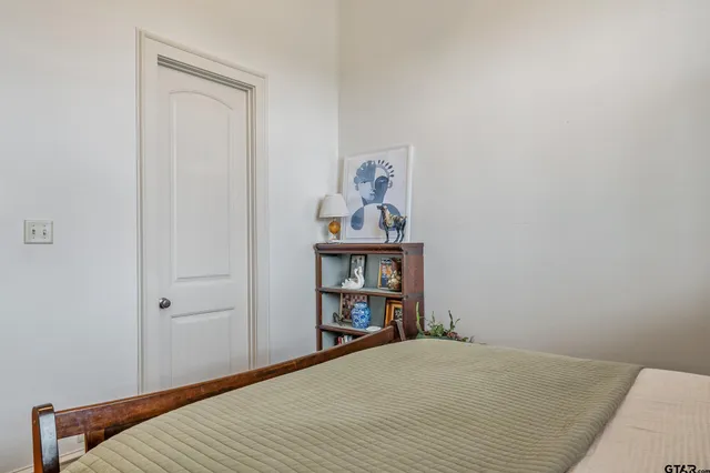 a bed room with a bed and a book shelf