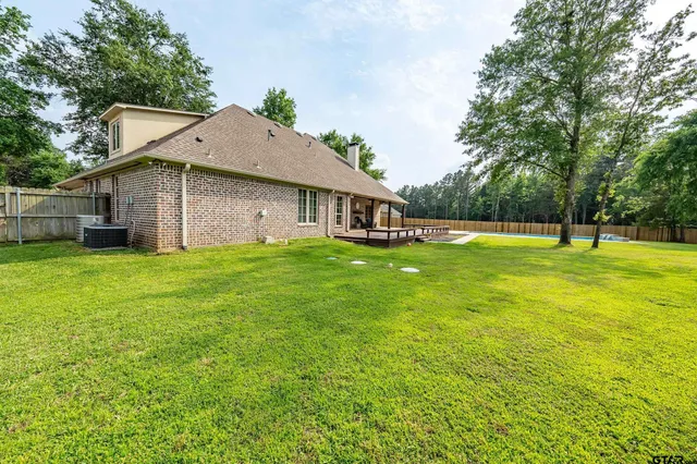 a view of a house with a yard and sitting area