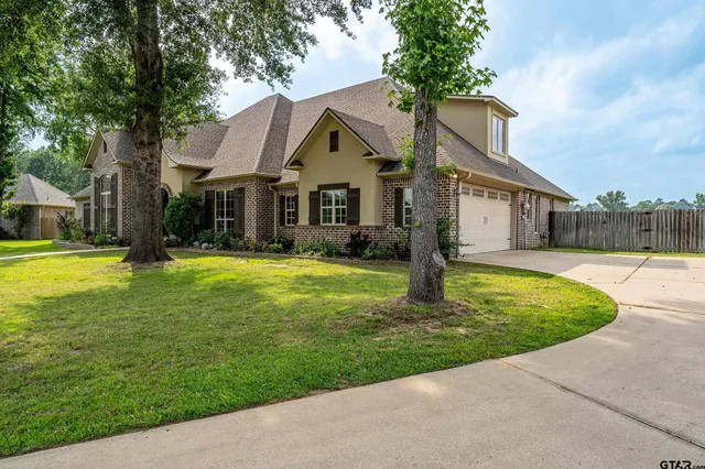 a front view of house with yard and green space