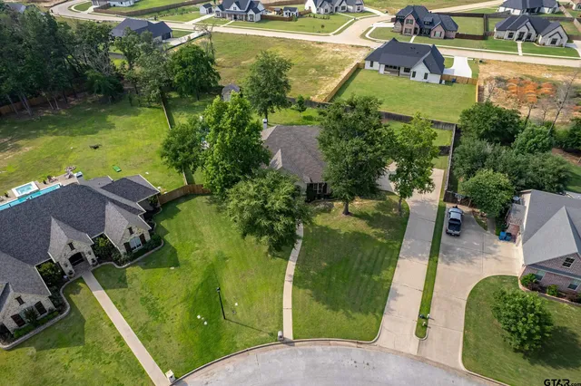an aerial view of a house with a yard basket ball court and outdoor seating