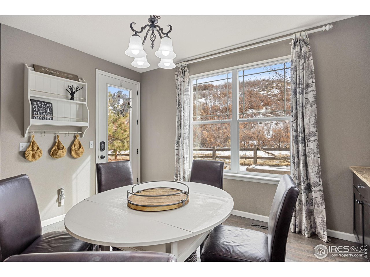 3183 Starry Night Loop Castle Rock, CO 80109 - Photo 12 of 40 a view of a dining room with furniture window and wooden floor