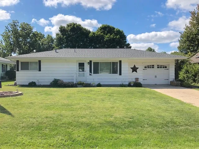 a front view of house with yard and seating area