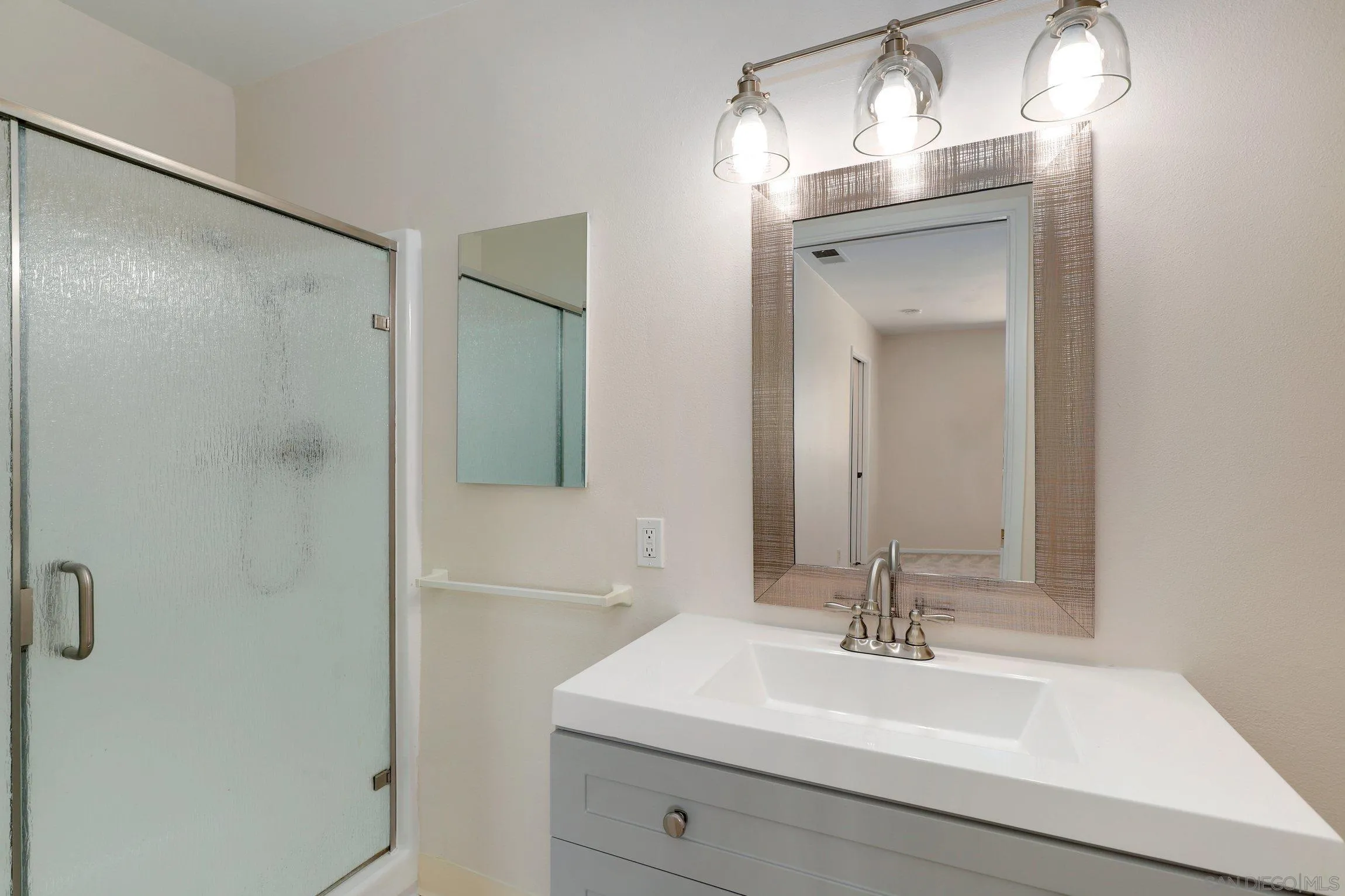 1666 Pala Lake Drive Fallbrook, CA 92028 - Photo 13 of 24 a bathroom with a sink a mirror and a shower