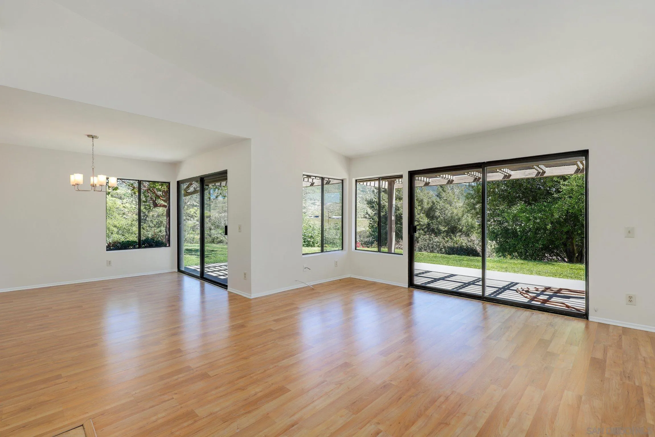 1666 Pala Lake Drive Fallbrook, CA 92028 - Photo 14 of 24 a view of an empty room with wooden floor and a window