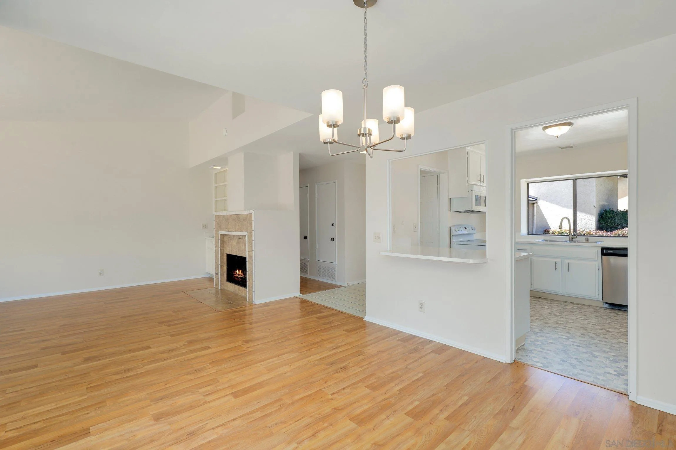1666 Pala Lake Drive Fallbrook, CA 92028 - Photo 5 of 24 a view of a big room with wooden floor and kitchen view