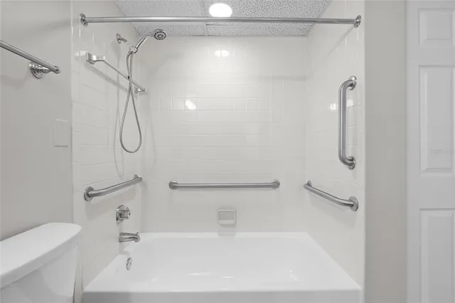 a bathroom with a bath tub with a shower