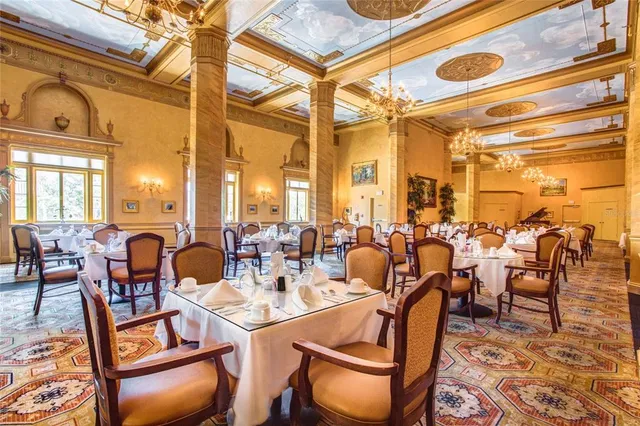 a dining hall with lots of tables and chairs