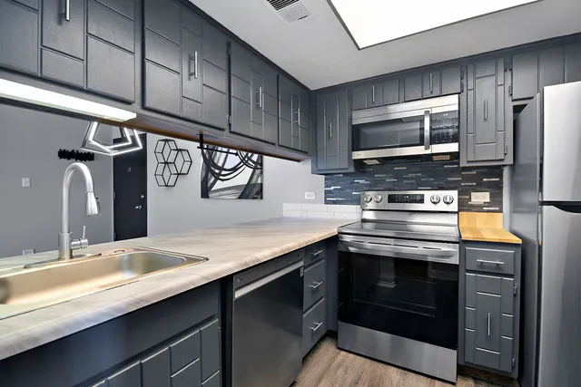 a kitchen with a stove and a refrigerator