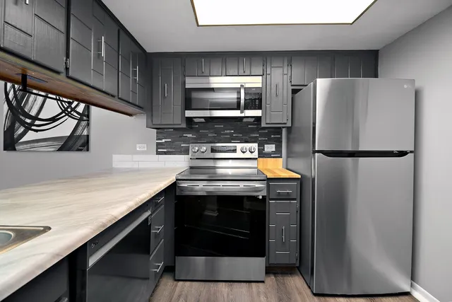 a kitchen with a sink a stove and cabinets