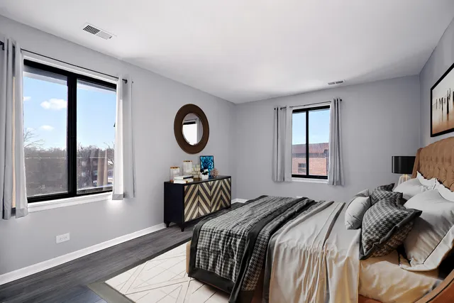 a bedroom with a large bed and a couch