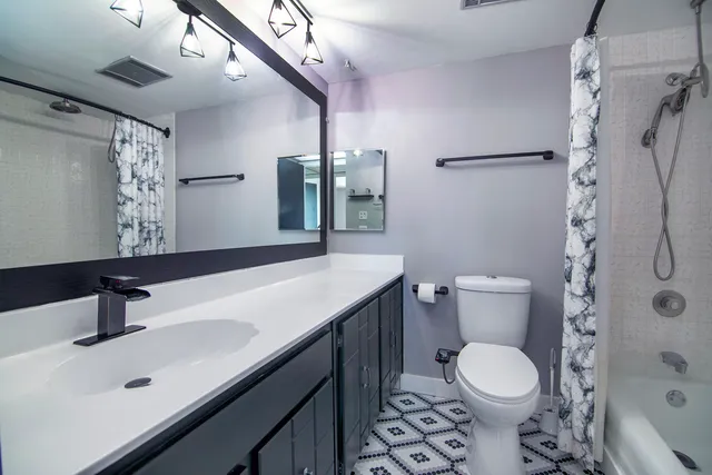 a utility room with dryer washer and a view of living room