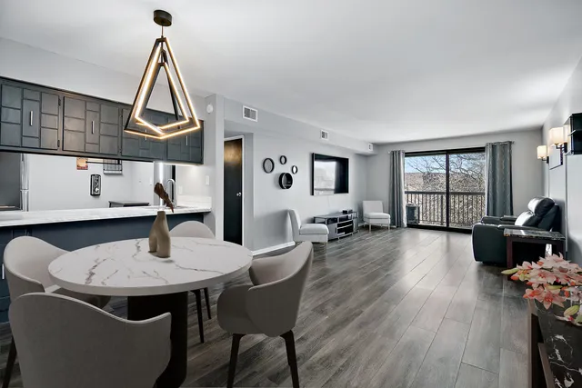 a living room with furniture wooden floor and a flat screen tv